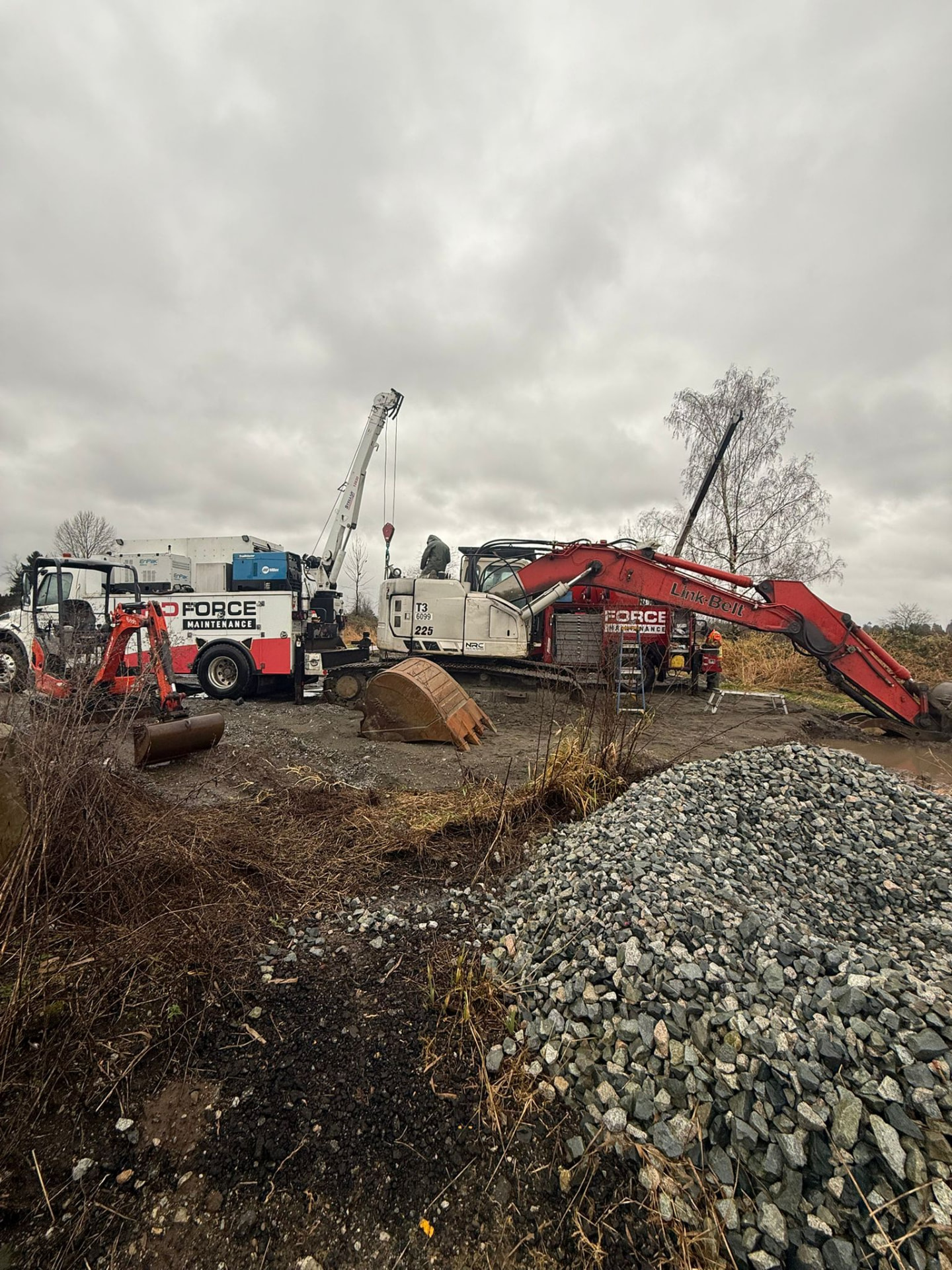 HD Force trucks servicing an excavator in the field